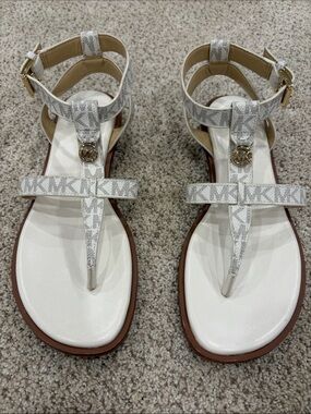 MICHAEL Michael Kors 6 1/2 cream/tan MK Logo T-Strap Sandals with Gold Accent
